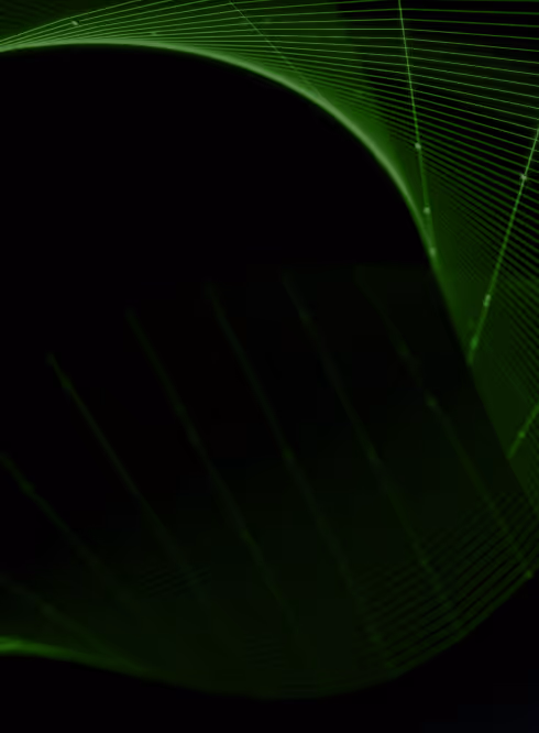 Four young adults collaborating around a MacBook laptop in a modern office space