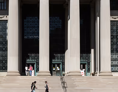 Pillars of a tall building with some people